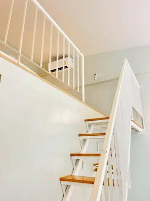 a white staircase in a home with white walls at THE BELONG BOUTIQUE HOTEL in Phuket Town