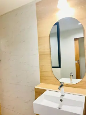 a bathroom with a sink and a mirror at THE BELONG BOUTIQUE HOTEL in Phuket Town