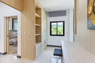 a dining room with a table and a window at Villa White Pool in Kamala Beach