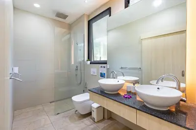 a bathroom with two sinks and a shower at Villa White Pool in Kamala Beach