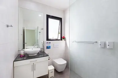 a white bathroom with a sink and a toilet at Villa White Pool in Kamala Beach