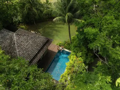 an overhead view of a swimming pool in a jungle at Anantara Layan Phuket Resort in Layan Beach