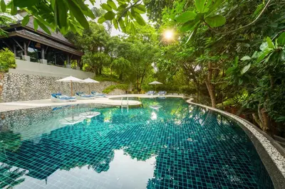 a swimming pool in a resort with trees at Anantara Layan Phuket Resort in Layan Beach