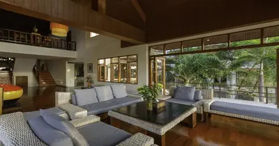a living room with couches and a table at Villa Yoosook in Patong Beach