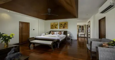 a bedroom with a bed and a living room at Villa Yoosook in Patong Beach