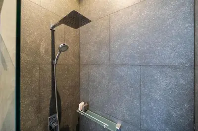 a shower with a shower head in a bathroom at Villa Lami - Luxury 3-Bedroom Modern Villa in Phuket with Private Pool, Gym & Sauna in Phuket Town
