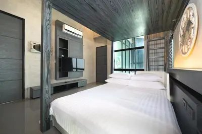 a bedroom with a large white bed with a tv at Villa Lami - Luxury 3-Bedroom Modern Villa in Phuket with Private Pool, Gym & Sauna in Phuket Town