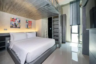 a bedroom with a white bed and a tv at Villa Lami - Luxury 3-Bedroom Modern Villa in Phuket with Private Pool, Gym & Sauna in Phuket Town