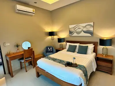 a bedroom with a bed and a desk and a bed sidx sidx sidx at Villa Tara nr Layan Beach in Bang Tao Beach