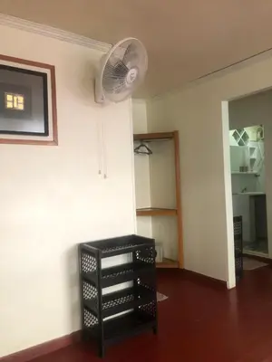 a room with a black cabinet and a fan at Phi Phi Dream Guest House in Phi Phi Don