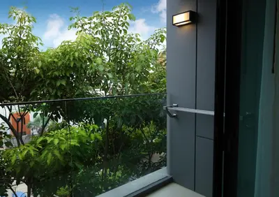an open door to a balcony with trees at Suite Vela 1BR Infinity Pool Mida Grande Surin in Surin Beach