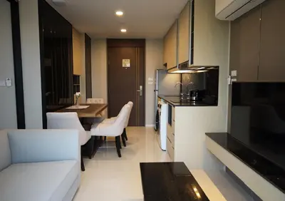 a living room with a kitchen and a dining room at Suite Vela 1BR Infinity Pool Mida Grande Surin in Surin Beach