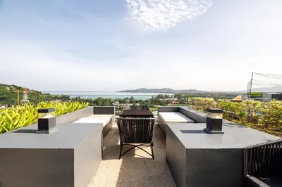 a view of the ocean from the balcony of a house at Suite Calista 2BRView JacuzziMida Grande Surin in Surin Beach
