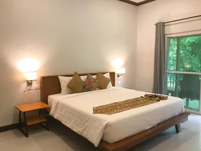 a bedroom with a large bed and a window at Koh Yao Yai Sea Breeze House เกาะยาวใหญ่ซีบรีซเฮ้าส์ in Ko Yao Yai