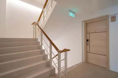 a staircase with a wooden door in a house at Bedline Hotel - SHA Certified in Phuket Town
