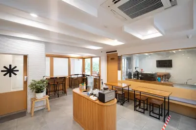 a restaurant with a bar and some tables and chairs at Bedline Hotel - SHA Certified in Phuket Town