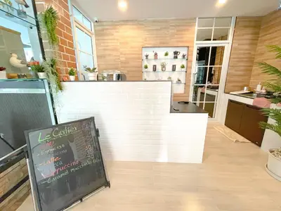 a restaurant with a counter with a chalkboard in front of it at Le Cartier in Patong Beach