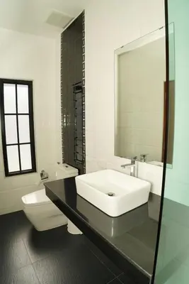 a white bathroom with a sink and a toilet at BAANKAAN Pool Villa 1 in Ban Khlong Haeng