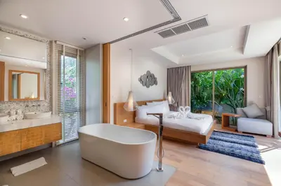 a bedroom with a bed and a bath tub and a bed at Sunny 3BR Villa with Private Pool at Bangtao Beach in Bang Tao Beach