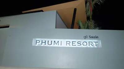 a sign for a phum resort on a wall at Phumi Resort in Thalang
