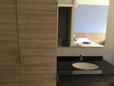 a bathroom with a sink and a mirror at Phumi Resort in Thalang