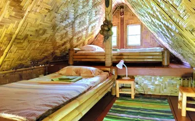 a bedroom with two beds in a tree house at Treehouse Holidays-Family house in Ko Yao Noi