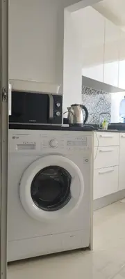 a white washer and dryer in a kitchen at Patong beach apartment for up to 4 person in Patong Beach