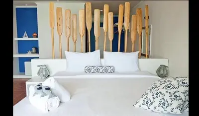 a bedroom with a white bed with shoes on it at AT SEA Patong in Patong Beach