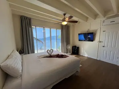 a bedroom with a bed with a large window at AT SEA Patong in Patong Beach