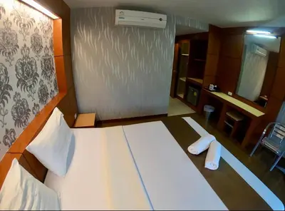 a bedroom with a large bed with two towels on it at Andaman Resort in Phi Phi Don