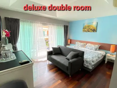 a bedroom with a bed and a couch at Thalassa Kata Beach in Kata Beach