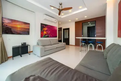 a living room with a bed and a couch at Sea and Sky Condominium by Lofty in Karon Beach