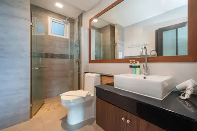 a bathroom with a toilet and a sink and a shower at Sea and Sky Condominium by Lofty in Karon Beach