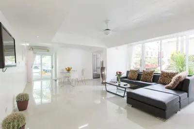 a living room with a couch and a table at Siam Palm Residence in Patong Beach