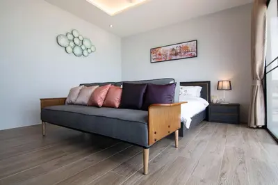 a living room with a couch and a bed at Koh Sirey Beachfront Pool Villa - 2 Bedrooms House in Phuket Town