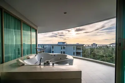 a bathroom with a bath tub on a balcony at The Ark at Veloche Group by Lofty in Karon Beach