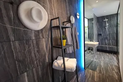 a bathroom with a sink and a mirror at INNLUXPHUKET in Ban Laem Hin