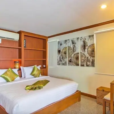 a bedroom with a large white bed in a room at Goodwill Beach House in Patong Beach