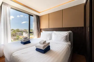 a hotel room with a bed with towels on it at Aristo 1 Phuket by RESAVA in Phuket Town