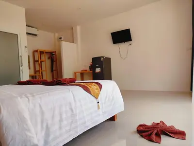 a bedroom with a bed and a tv on the wall at The mantra resort in Ko Yao Yai