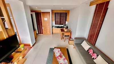 a living room with a couch and a television at Aonang Phu Dahla Private Pool & Sea View - SHA Plus in Ao Nang Beach