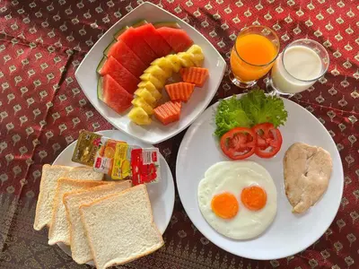 a table with two plates of breakfast foods and drinks at Krabi Klong Muang Bay Resort in Klong Muang Beach
