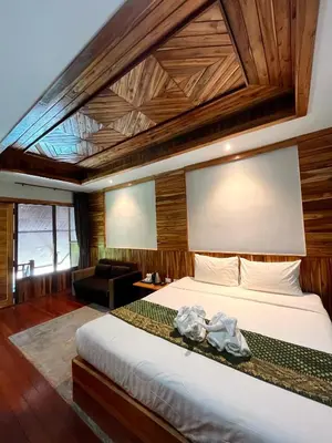 a bedroom with a large bed with a wooden ceiling at Krabi Klong Muang Bay Resort in Klong Muang Beach
