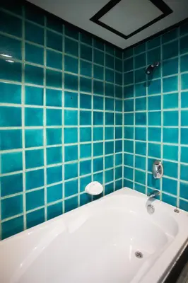 a blue tiled bathroom with a bath tub at Golden Beach Resort in Ao Nang Beach