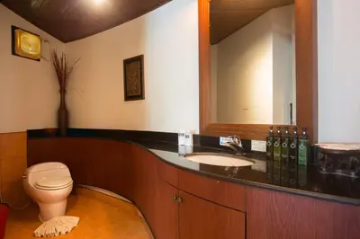 a bathroom with a toilet and a sink and a mirror at Golden Beach Resort in Ao Nang Beach