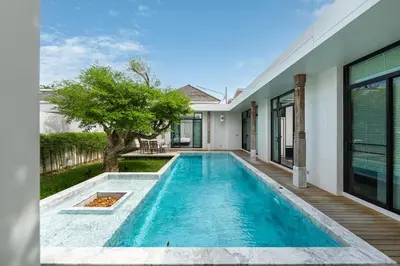 a swimming pool in the backyard of a house at MONO LUX Villa x MonthStayZ Thailand in Chalong