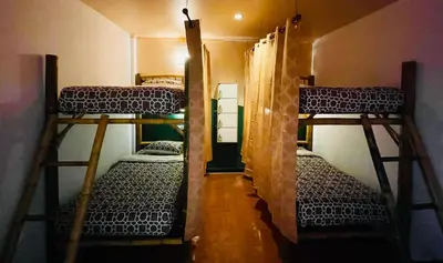 a room with three bunk beds in a room at Passion Nai Harn Guesthouse in Nai Harn Beach