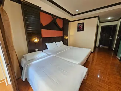 a bedroom with two beds in a room at Nanai 2 Residence Patong Phuket in Patong Beach