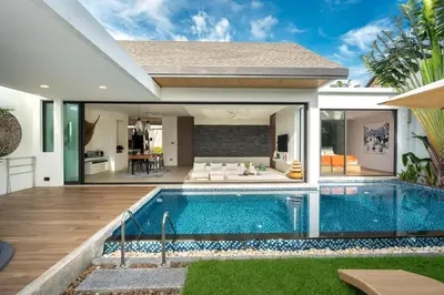 a villa with a swimming pool and a house at Sunny Day Dream Villa - Nai Yang Beach in Thalang