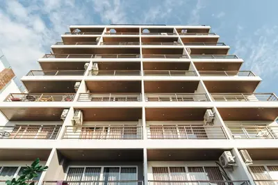 a tall white apartment building with balconies at Private apartment at Bayshore by Lofty in Patong Beach